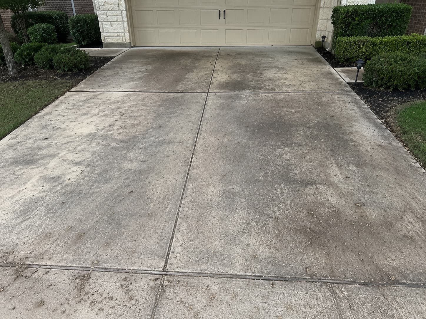 Driveway before — dirty, stained concrete